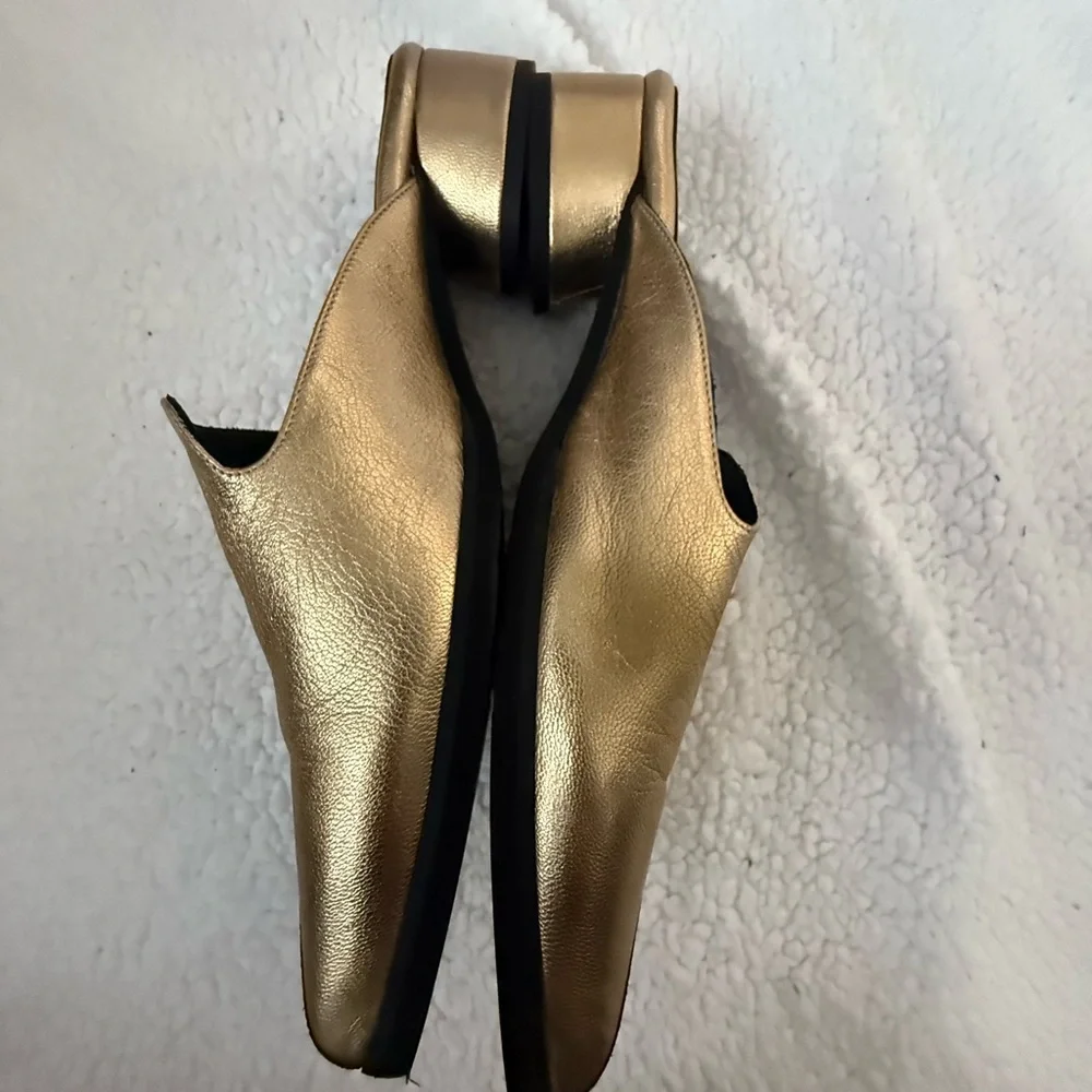 Andre Assoues gold and black slip on pointy style